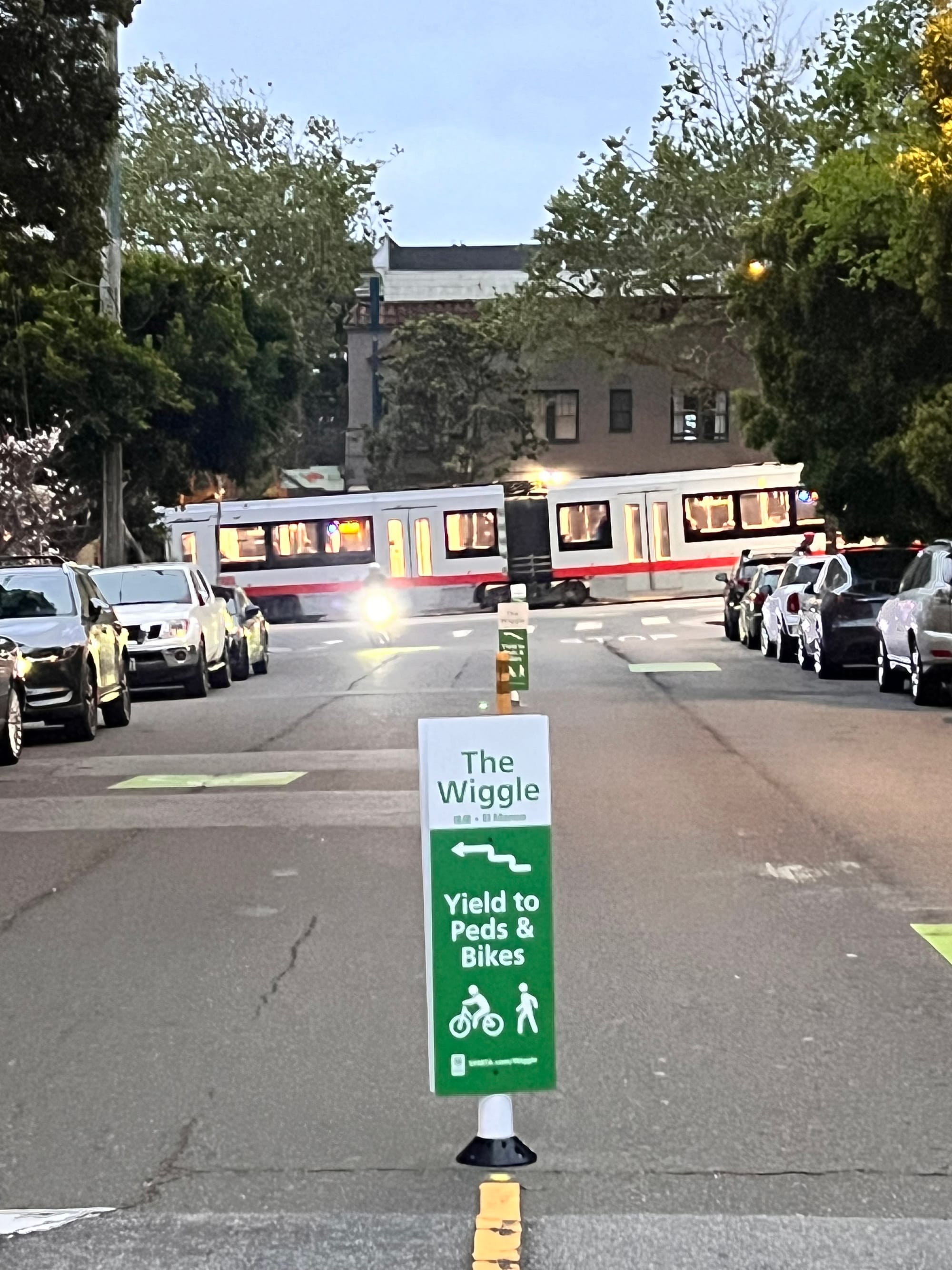 A sign in the median saying "The Wiggle Yield to Peds & Bikes"