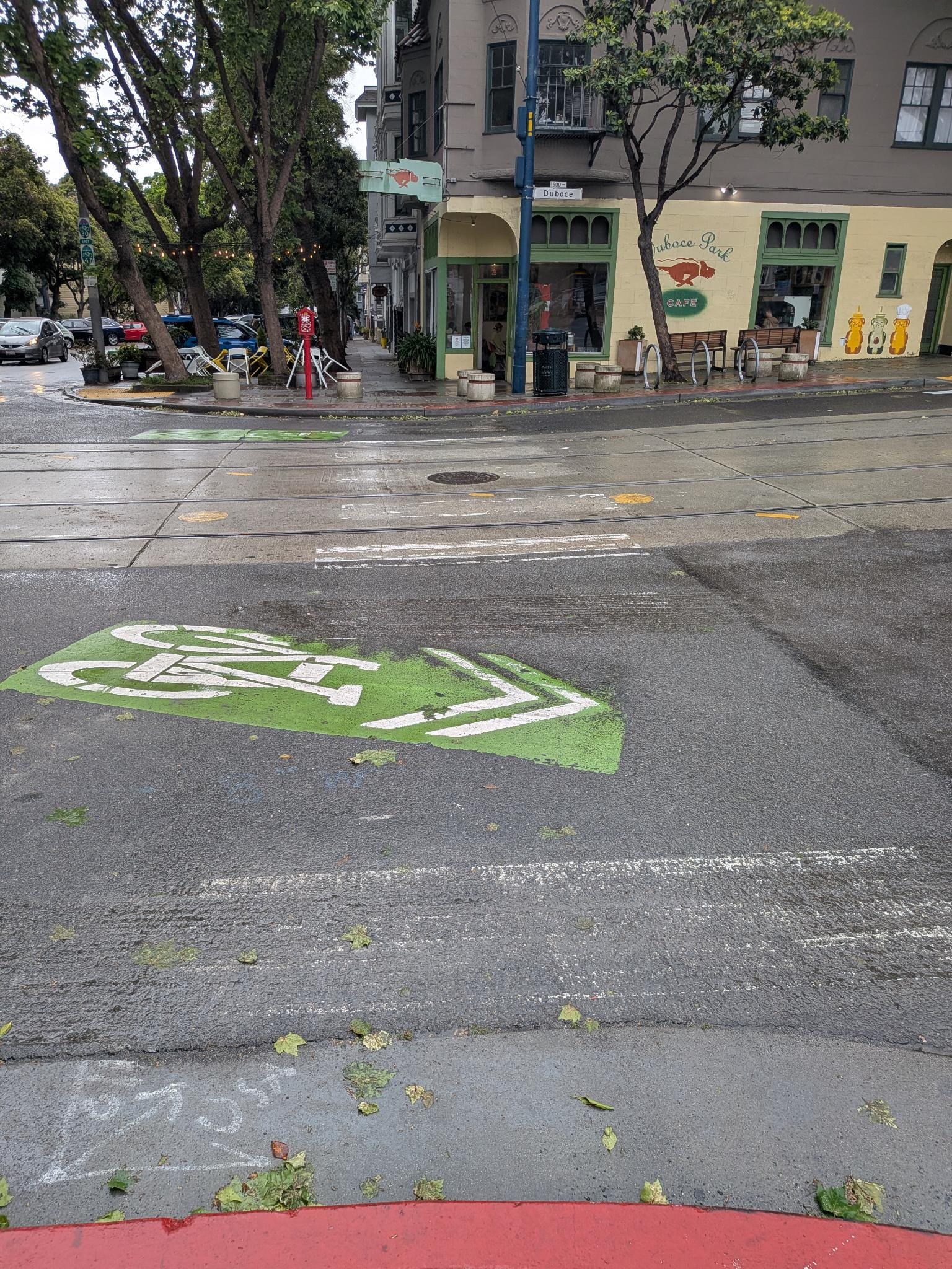A street with a heavily faded crosswalk connecting two sides of the street